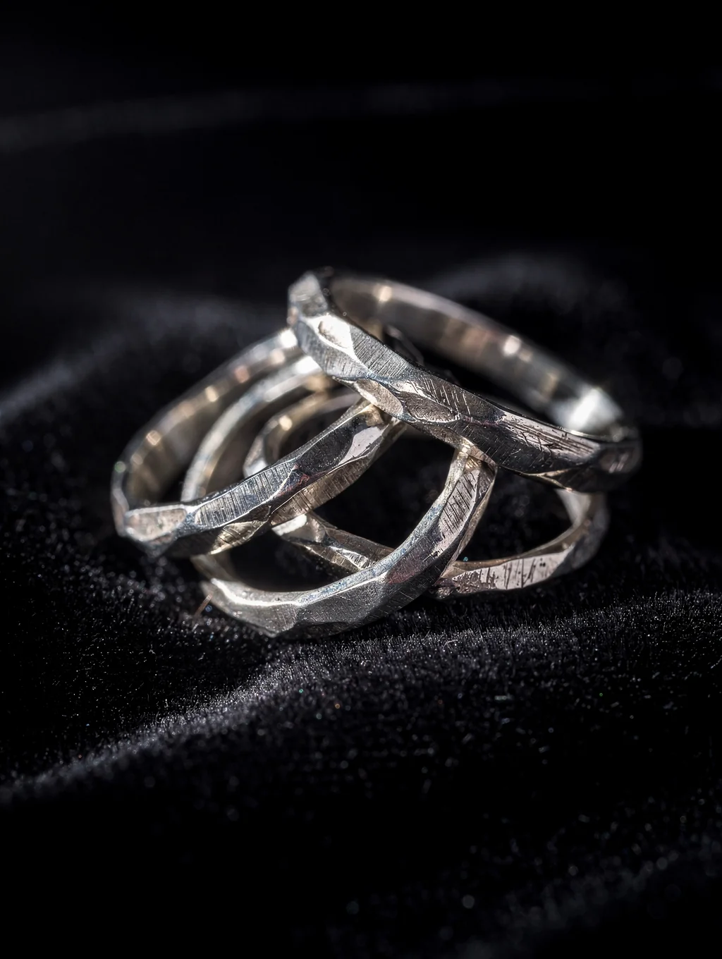 Hand-hammered 925 sterling silver jewelry in chiaroscuro studio lighting